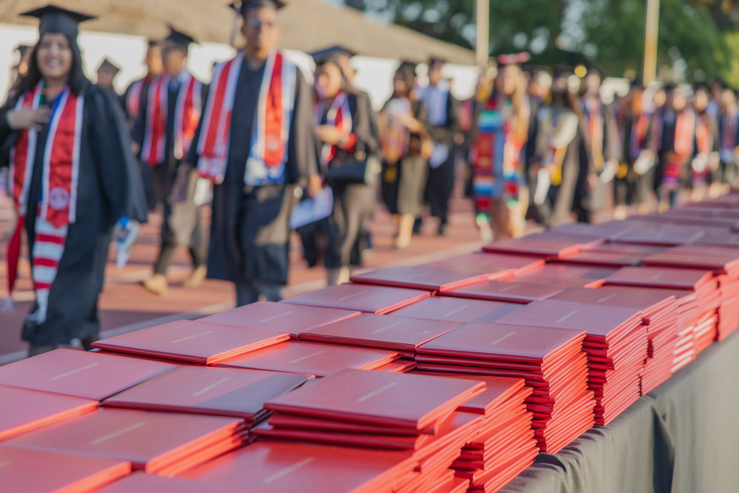 BC graduates walking by their awaiting diplomas