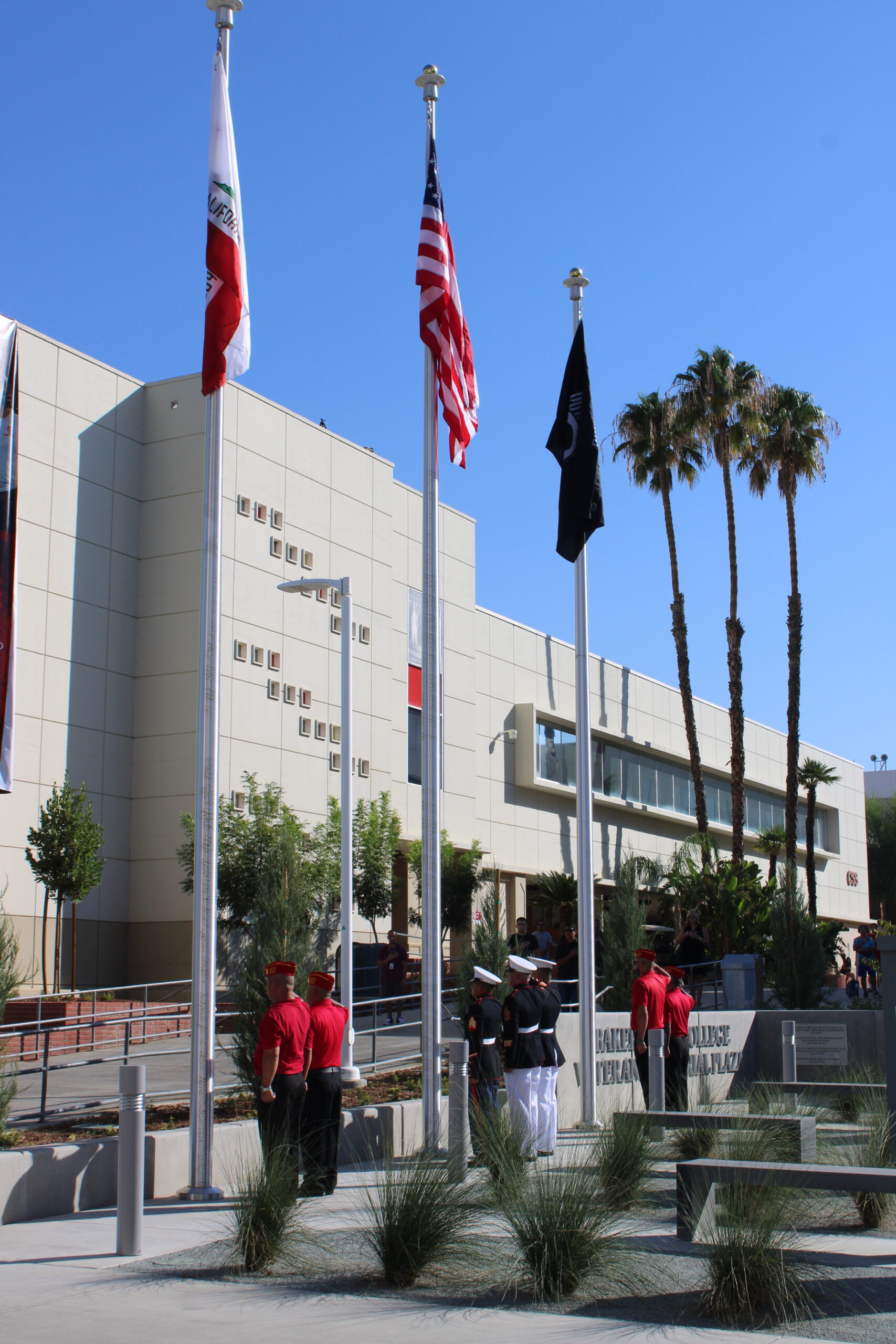 Soldiers putting up the flags on the poles for the new Veterans Plaza.