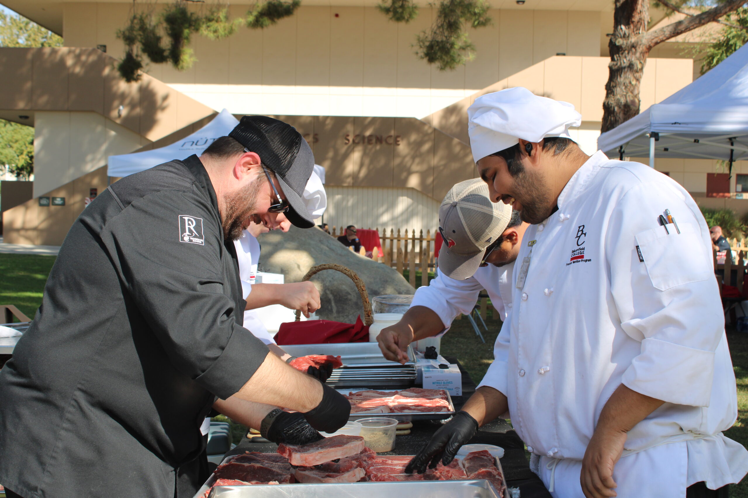BC Culinary team preparing steaks and hot dogs