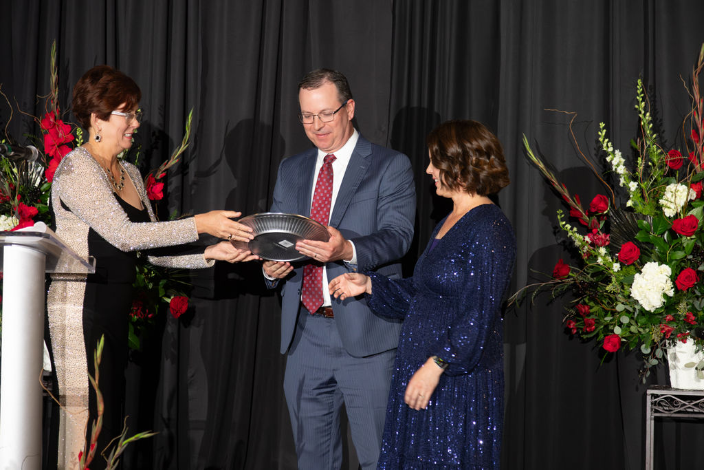 Cheryl Scott awarding Jeff and Amy Bell