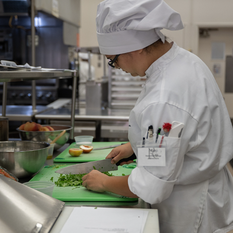 Culinary student chopping vegetables