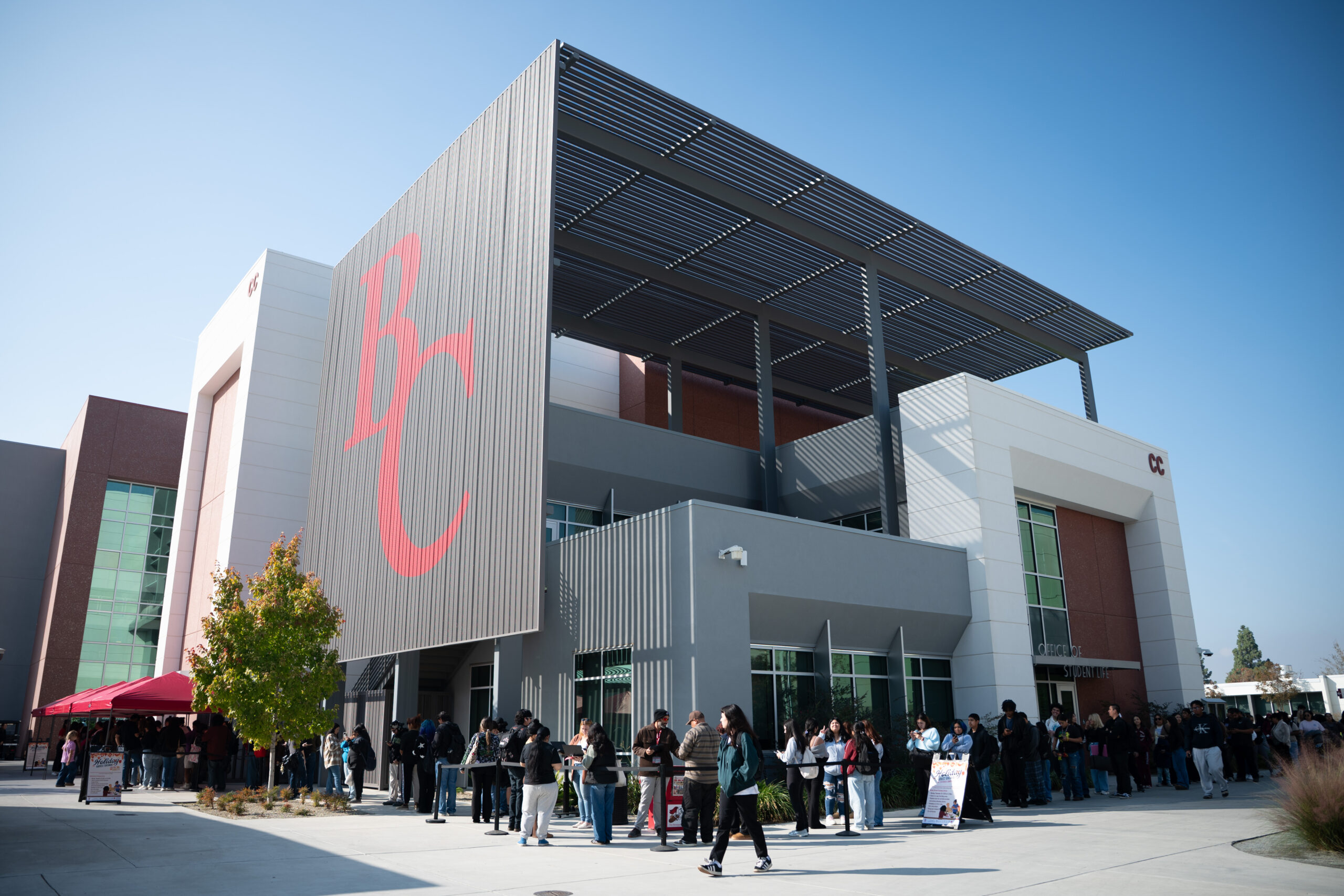 Dean of students giving a turkey to a staff member