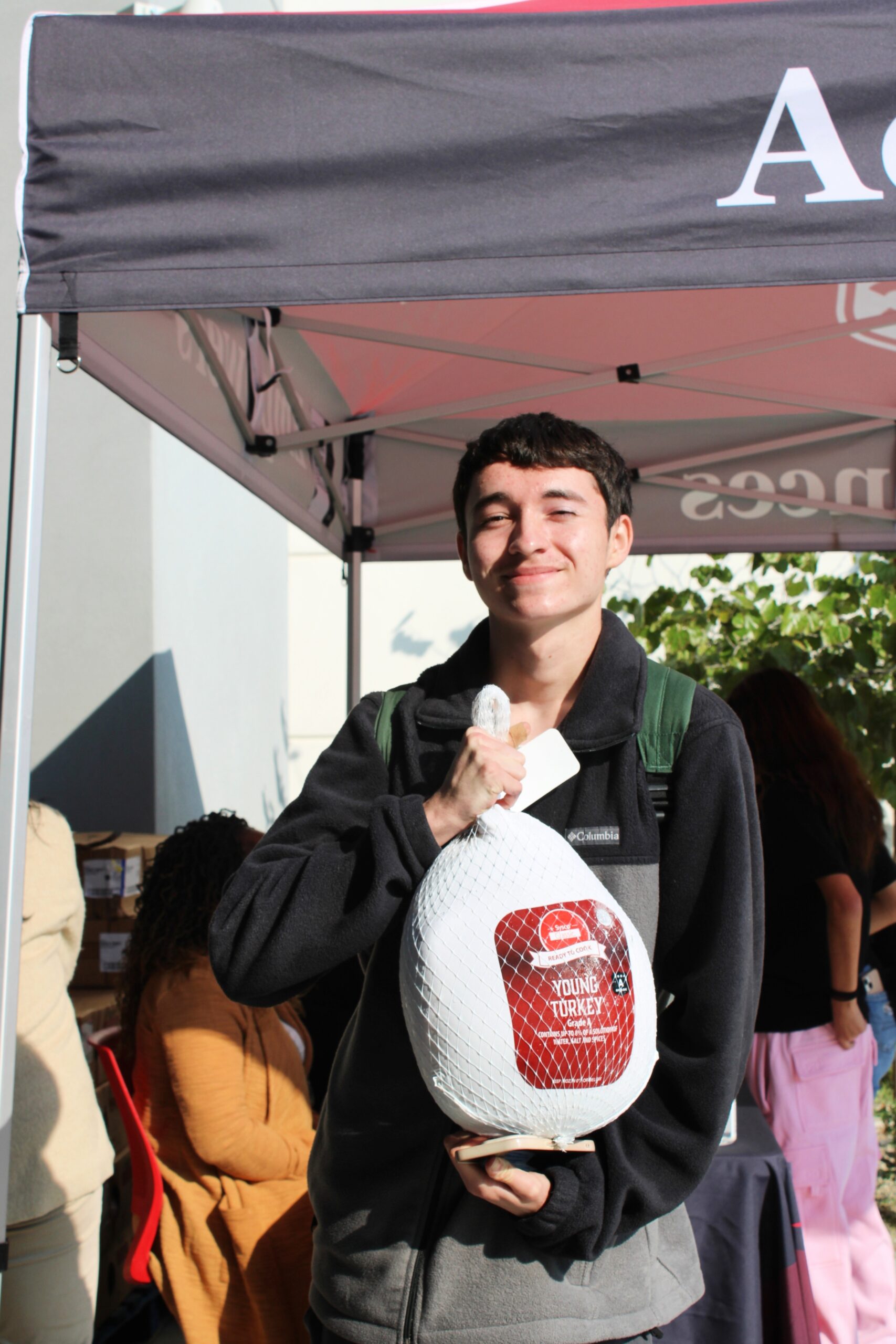 Student posing with a turkey