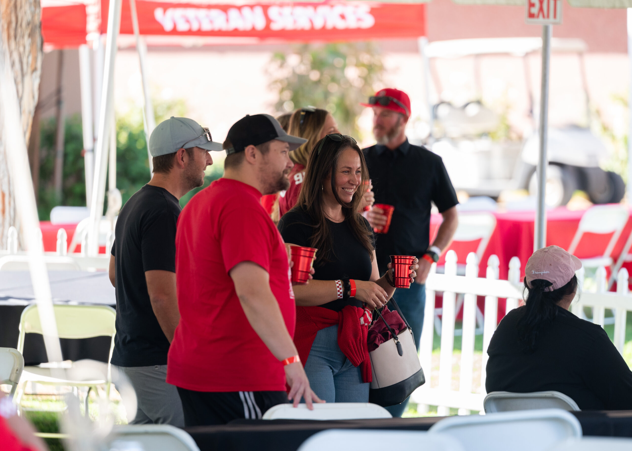 Alumni laugh and enjoy food together at the Bakersfield College Alumni BBQ.
