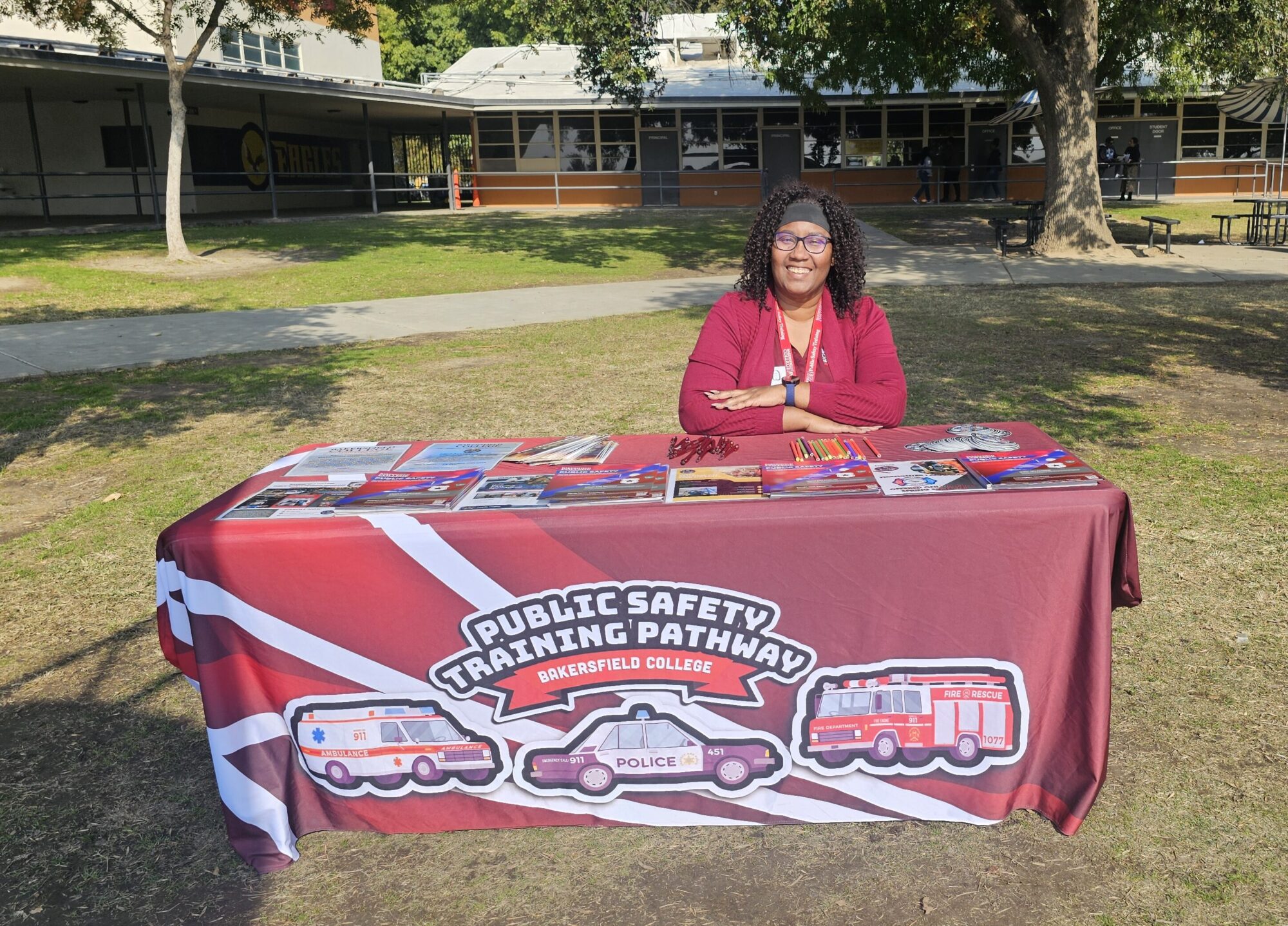 Tiffany Sagbohan sitting at a public safety booth table