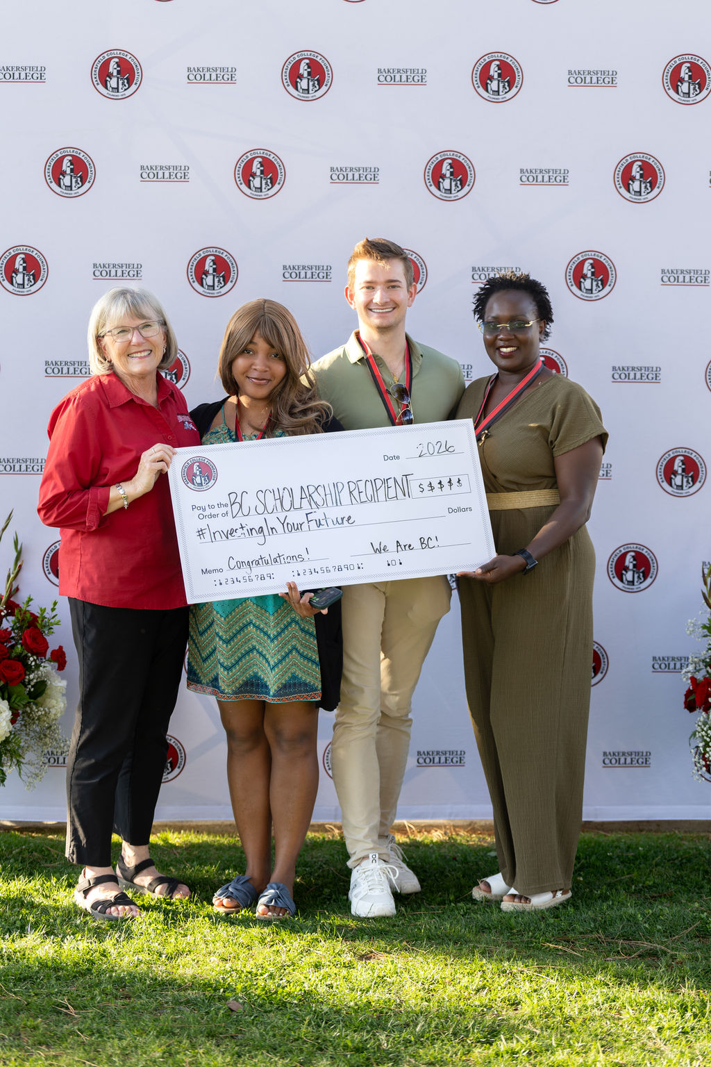 Students holding up a scholarship check