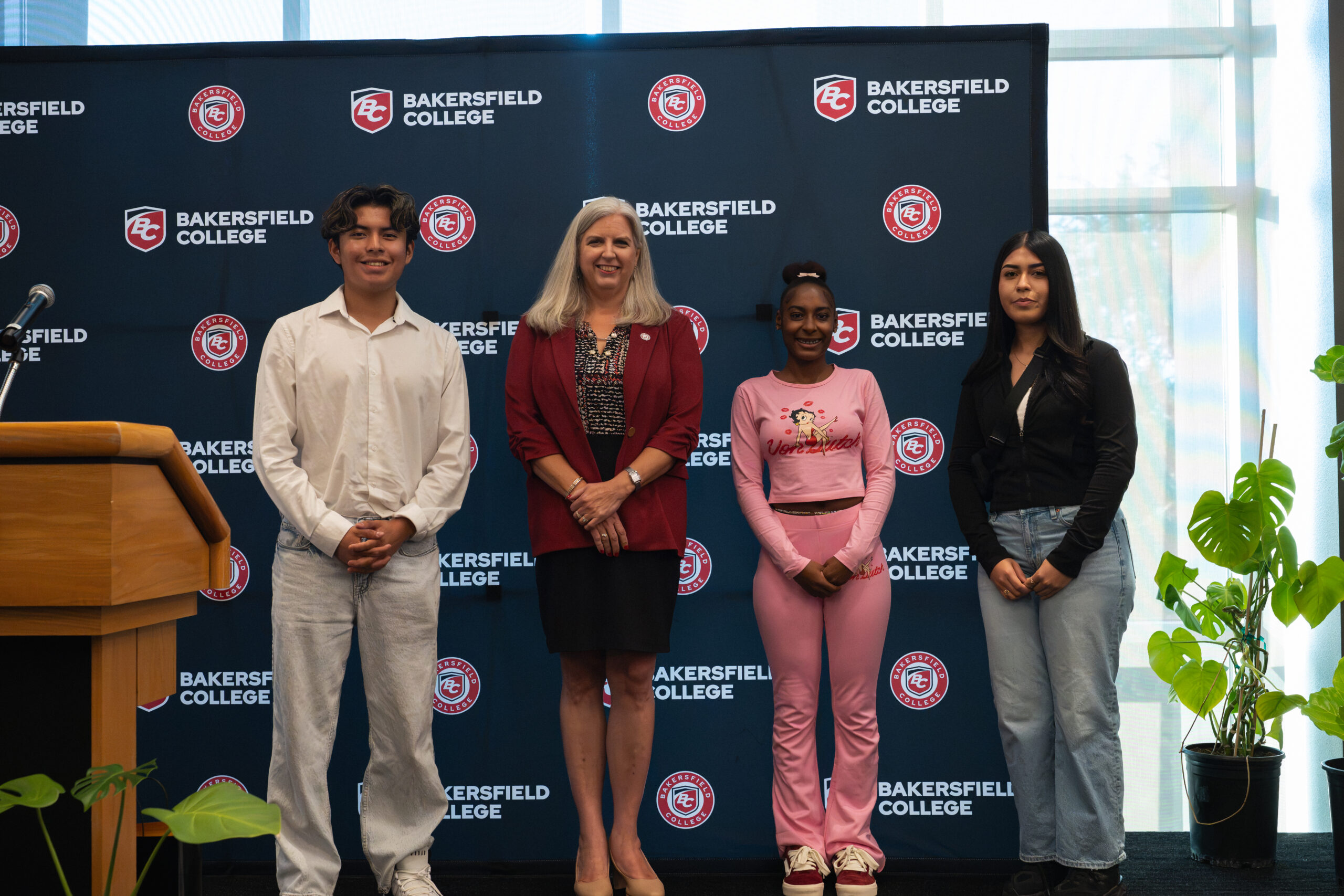 President Pfluger and three students receiving President's Scholars recognition