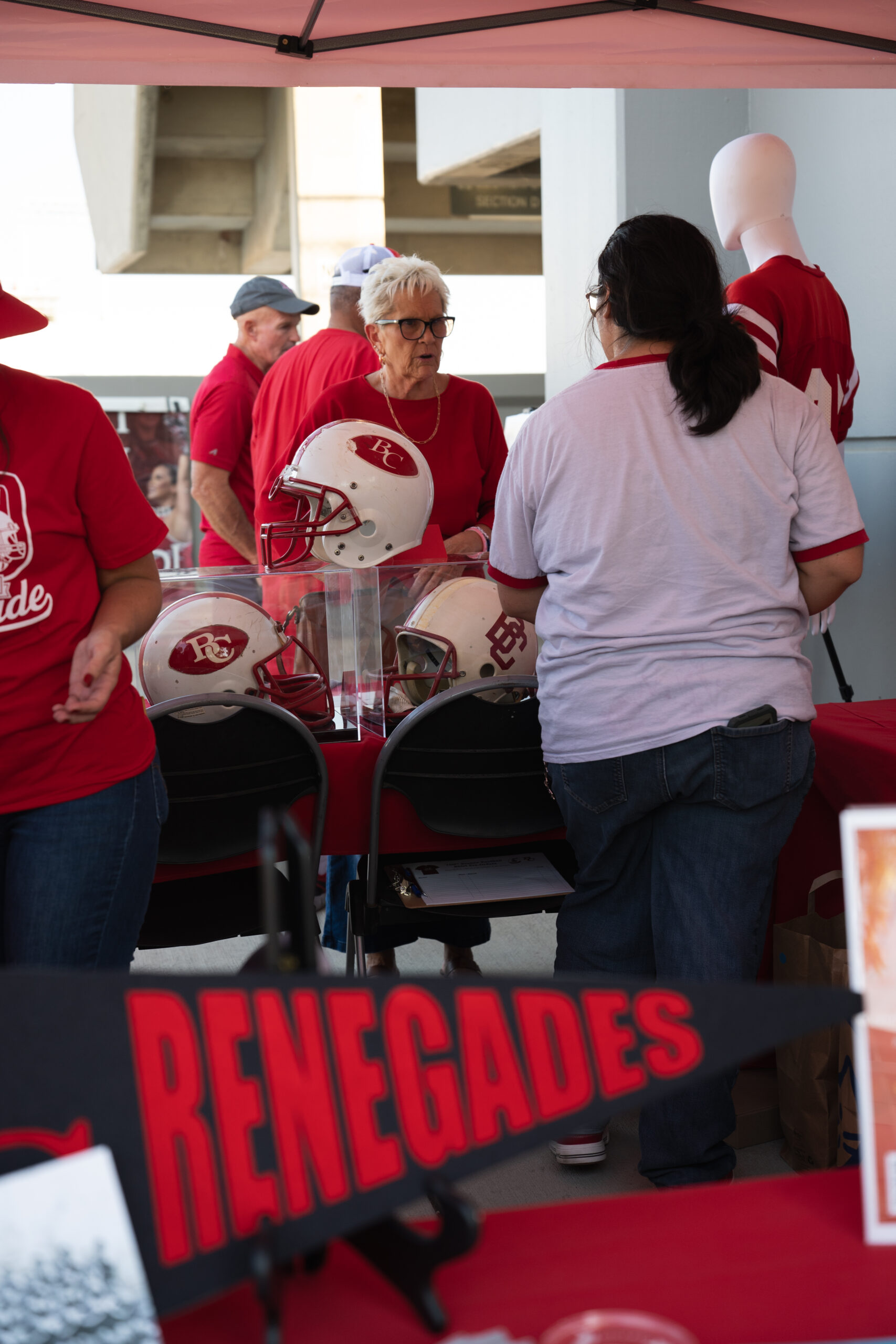 Visitors view vintage BC football helmets and memorabilia at the Archives booth