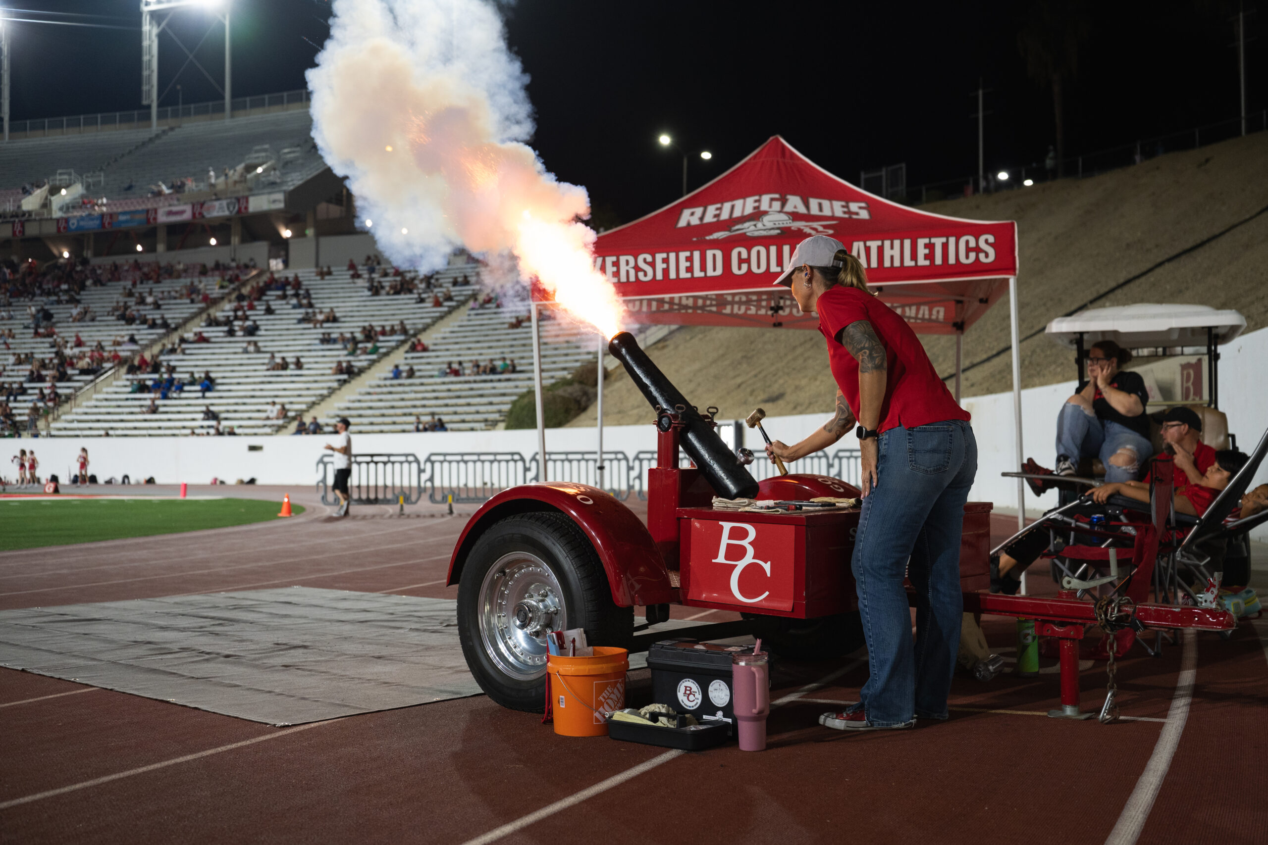 A BC staff member fires the Renegade cannon from the sideline during the football game.