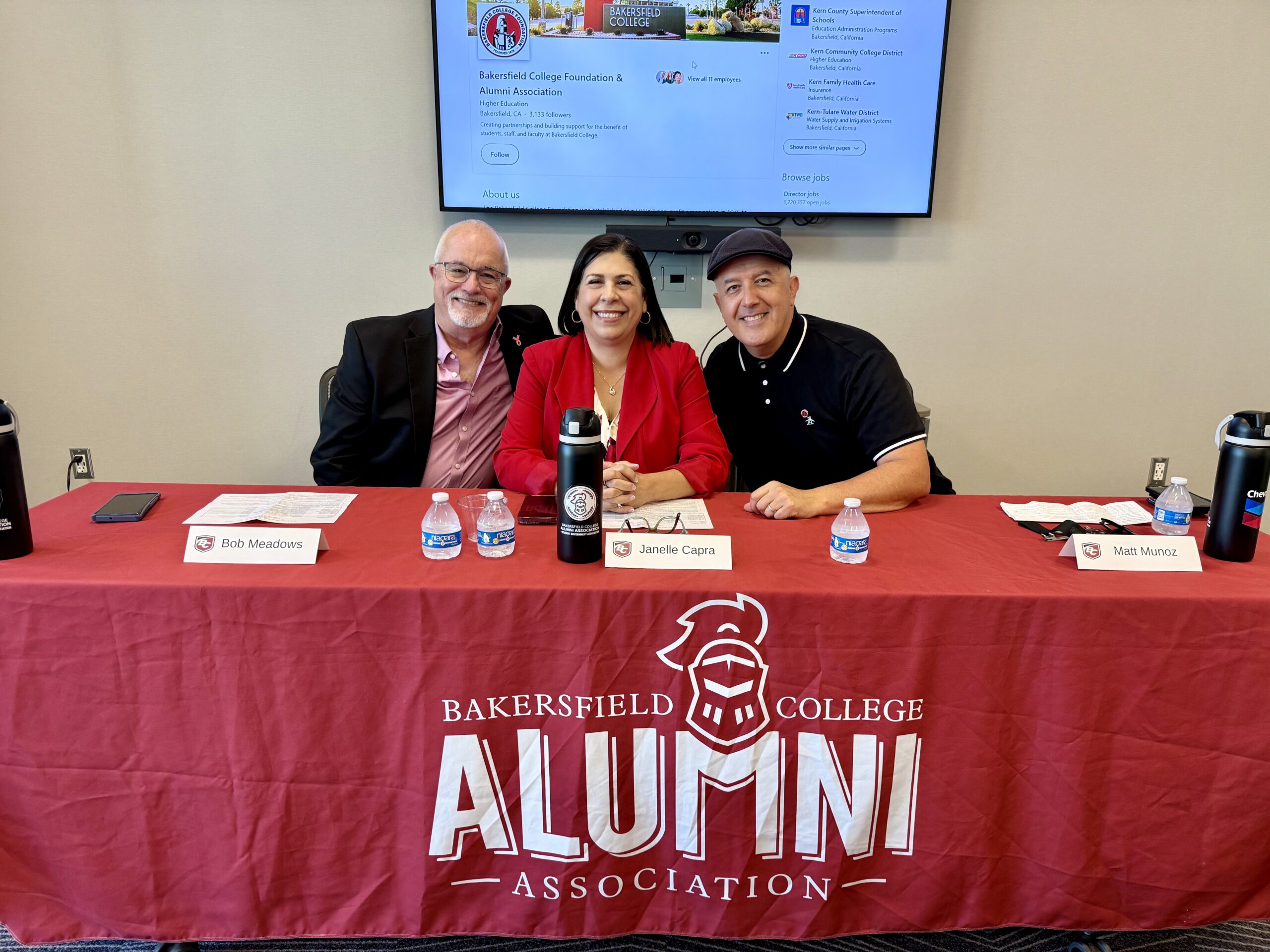 Alumni panelists Bob Meadows, Janelle Capra and Matt Munoz smile for a photo